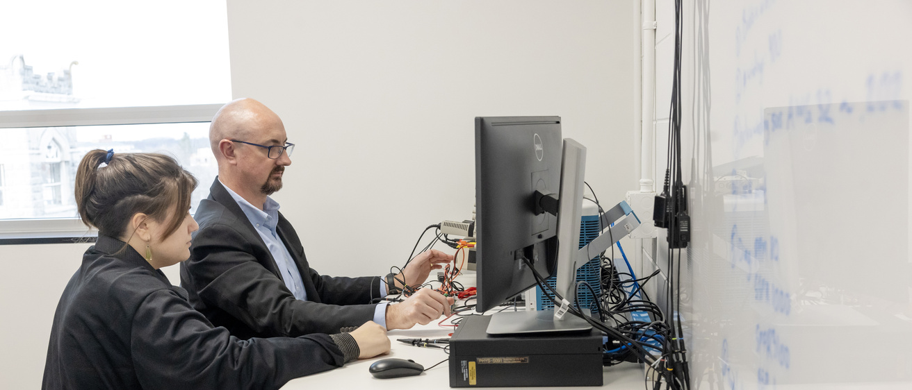 David Miles works with a graduate student in the Iowa Spaceflight Laboratory.