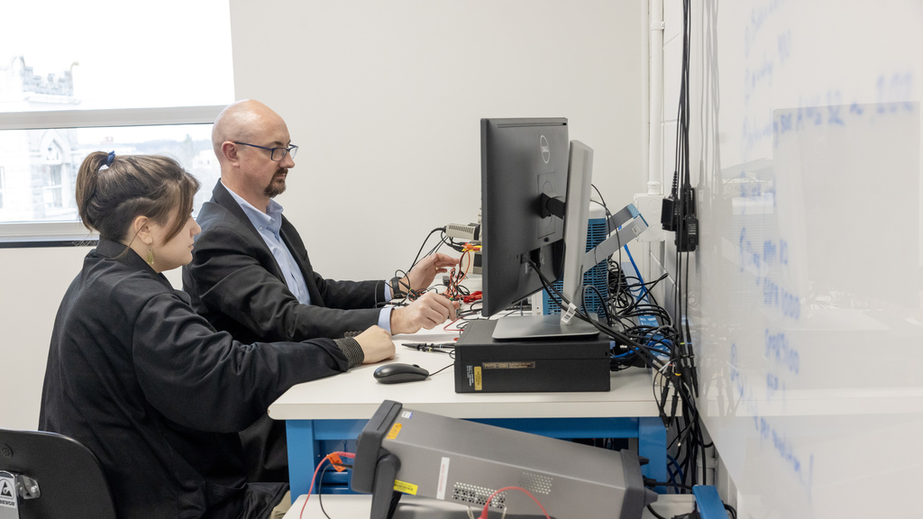 David Miles works with a graduate student in the Iowa Spaceflight Laboratory.